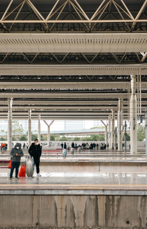 two men are walking underneath an airport or terminal