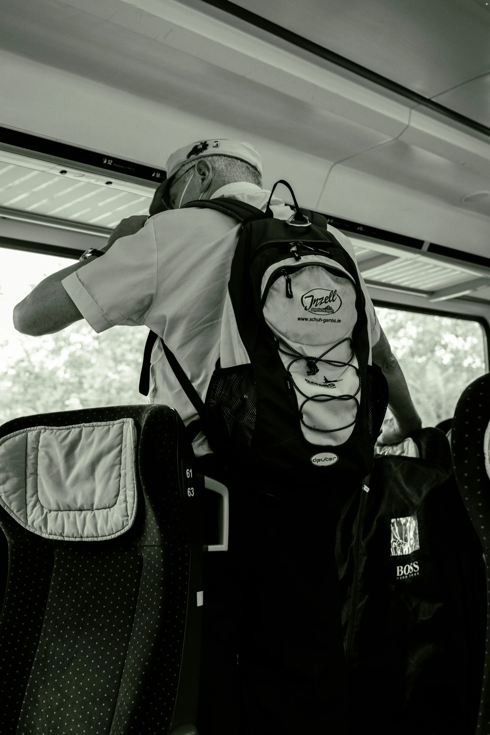 several backpacks and hat on the back of an airplane