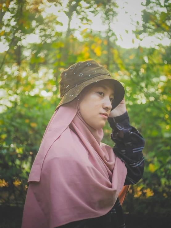 a young person in a pink outfit holding a camera