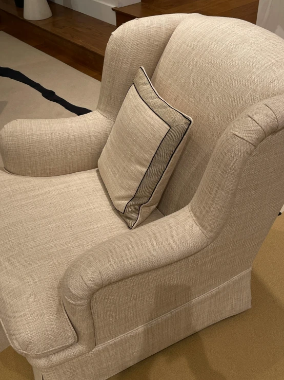 a large tan reclining chair with a pillow on it