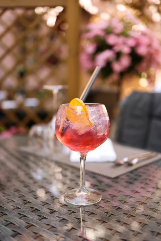 an orange peel in a wine glass with ice