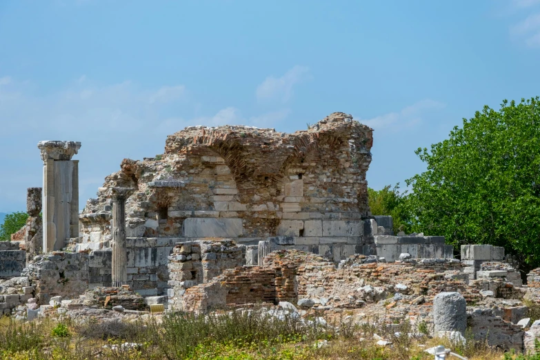 the ruins of a large, ancient building with trees in front