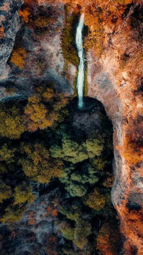 a small waterfall running out of a mountain side