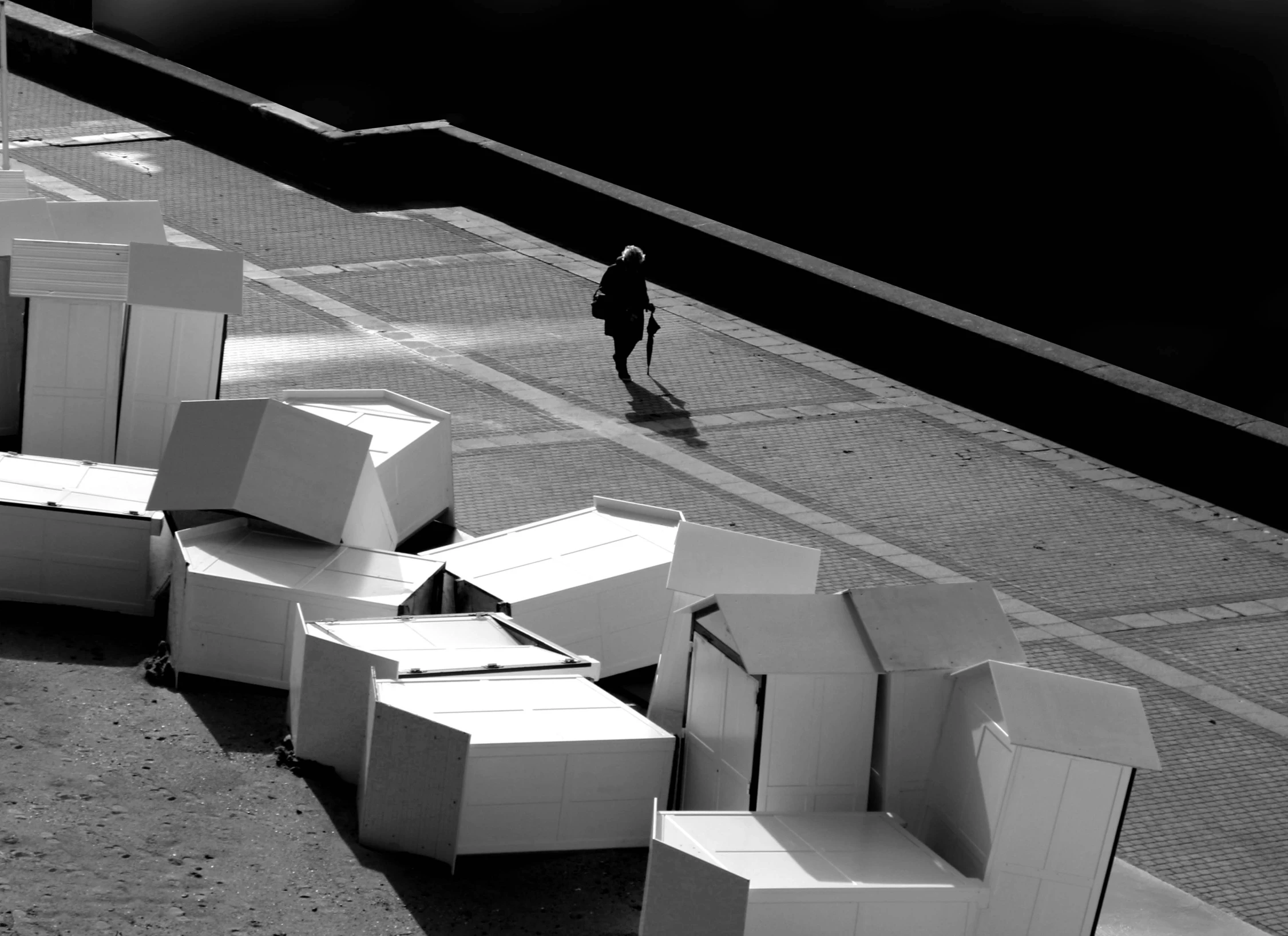 black and white po with person walking near cardboard boxes