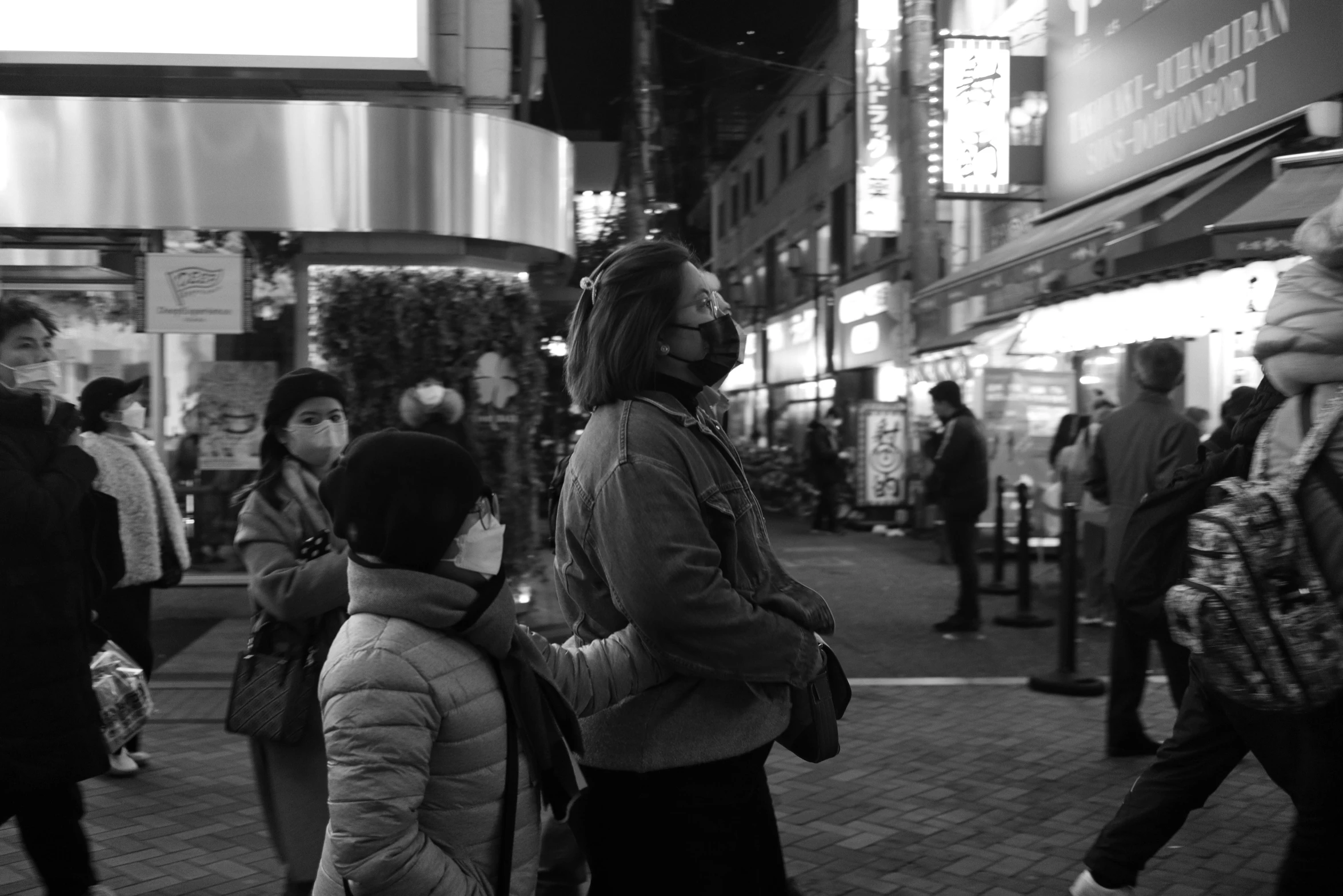 the man is waiting in line for his turn to cross the street