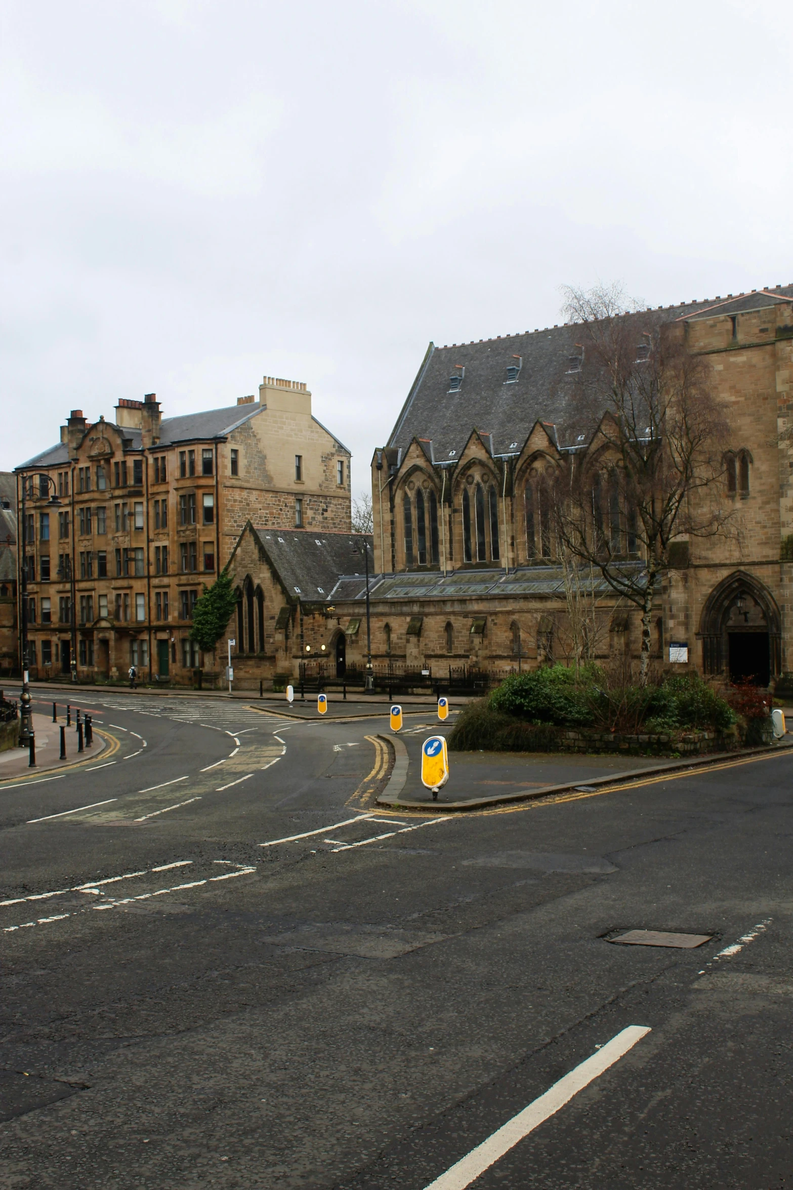 a view of a road with a church and old buildings