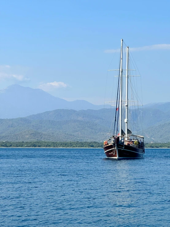 two tall boats are in the middle of a lake