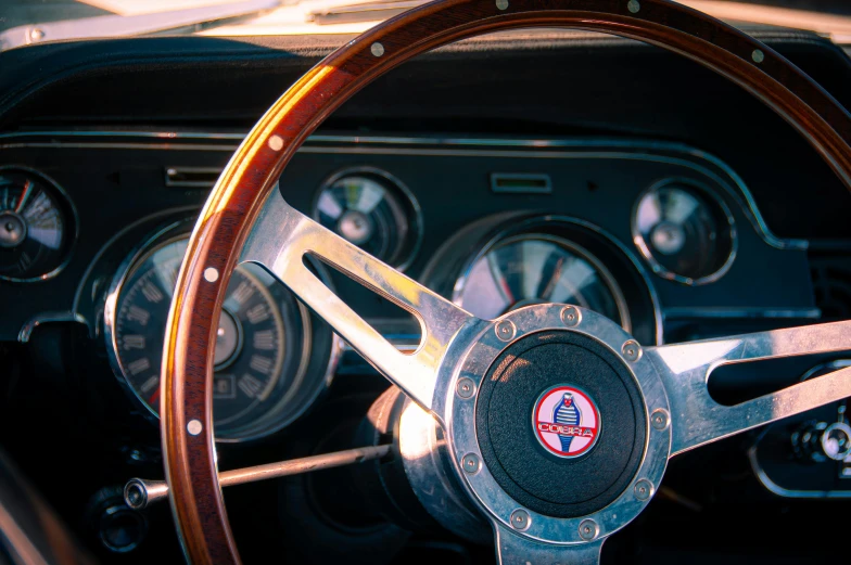 the steering wheel and dashboard of an antique classic car