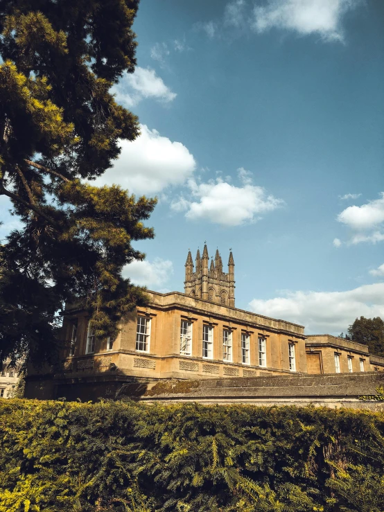 an old building with a big spire and clocks on the clock tower