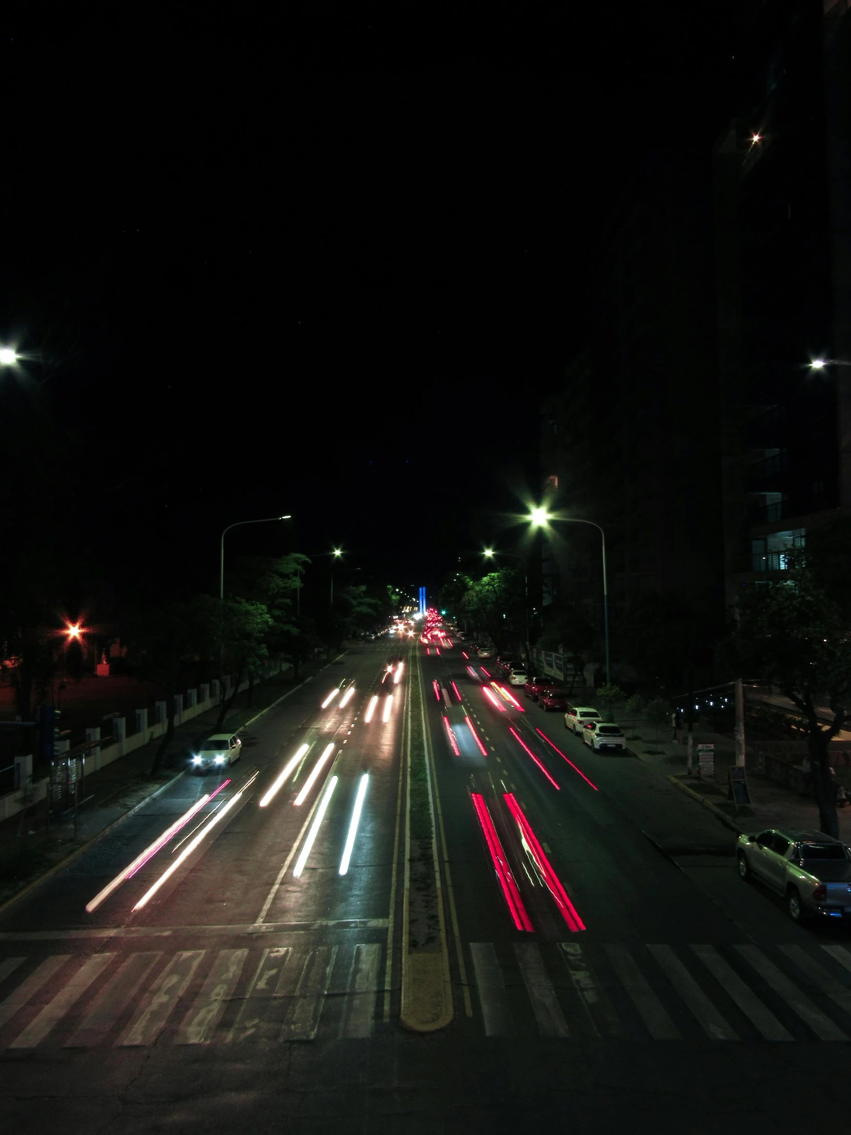 traffic at night as seen from the top of an intersection