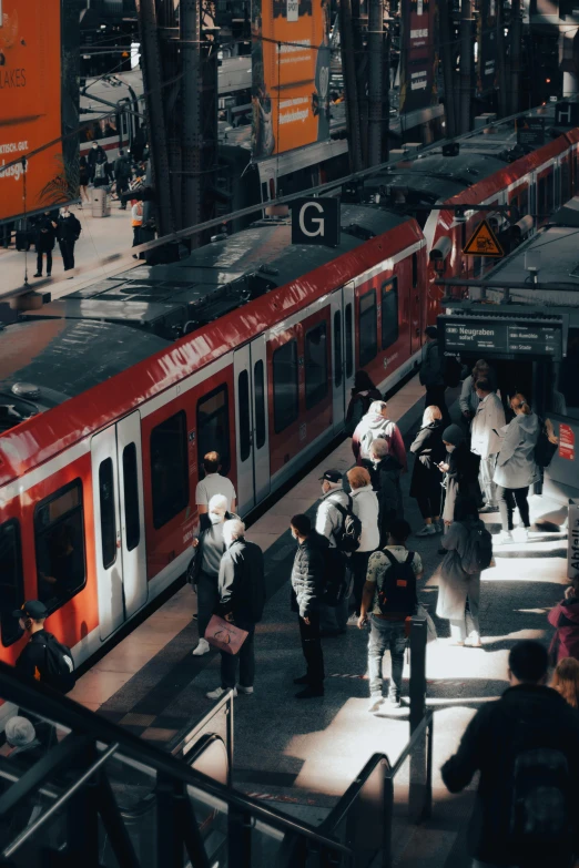 passengers getting on and off the trains at the station