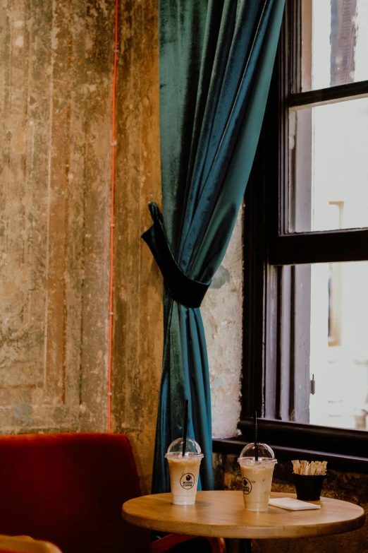 a wooden table sitting next to two window