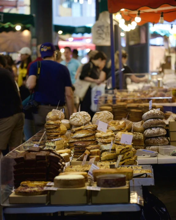 many sandwiches and other foods at an outdoor market