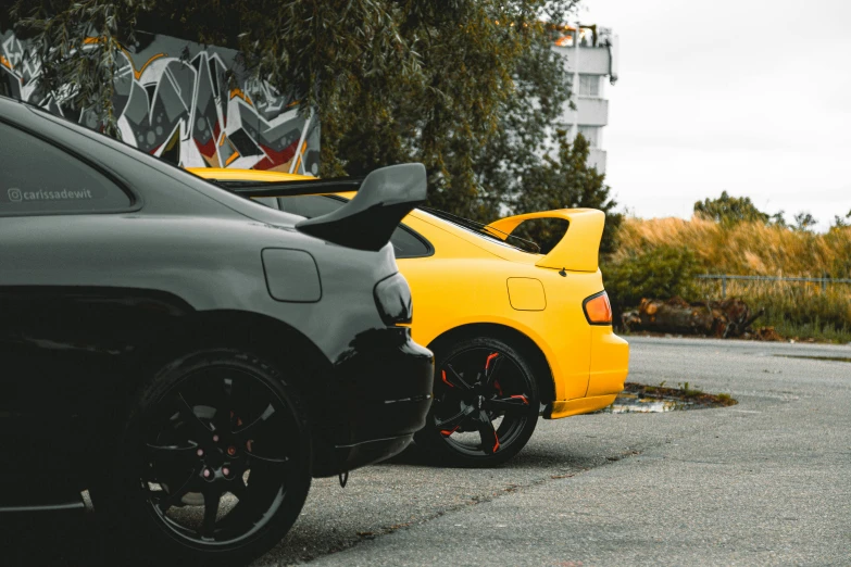 two parked cars side by side on a street