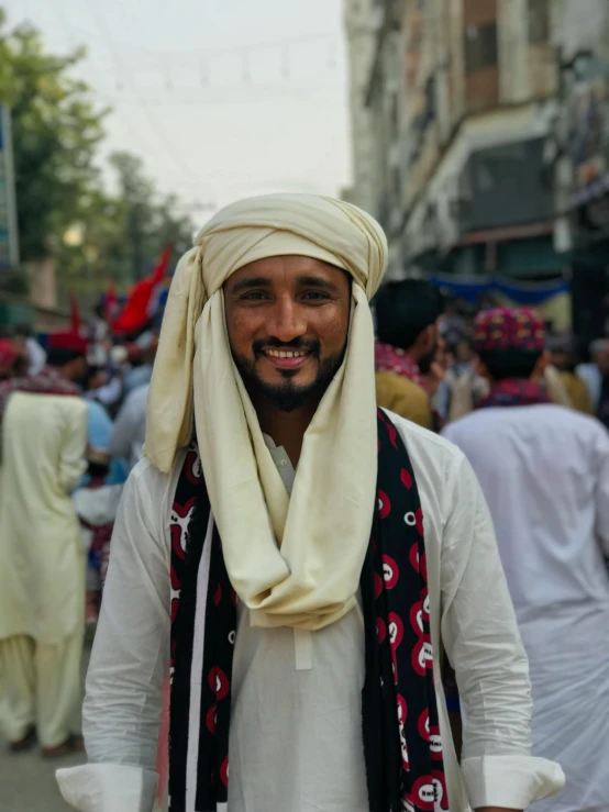 a man with a headscarf stands outside