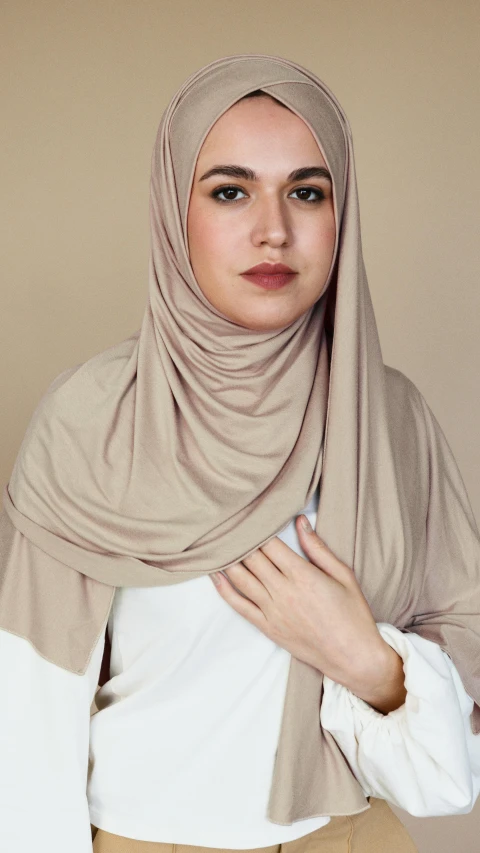 young woman wearing beige colored shawl