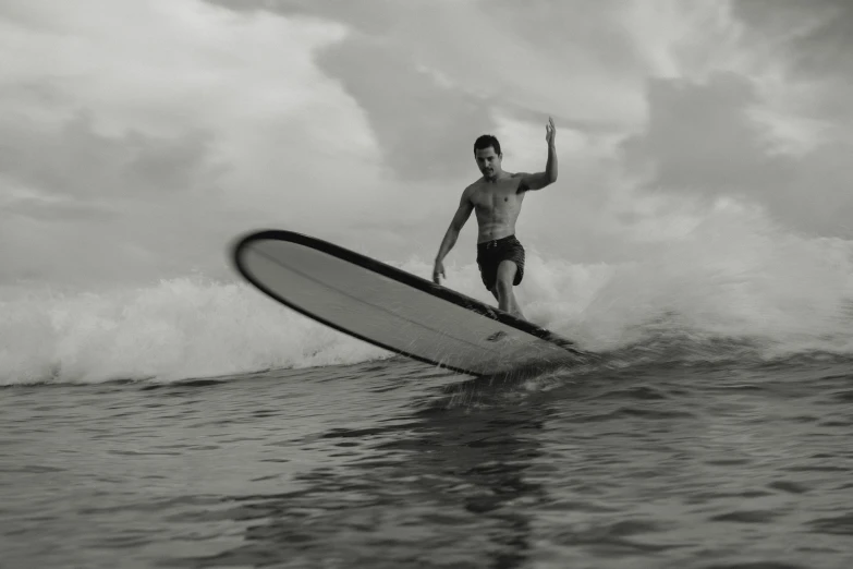 the man is surfing on the surfboard in the water