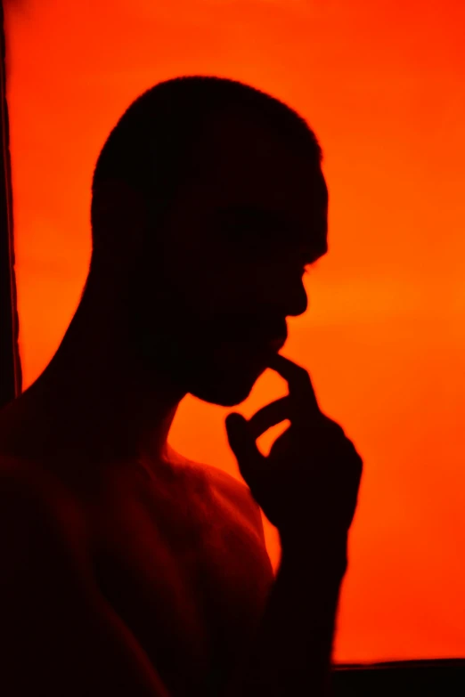 a person in silhouette holding soing in his hands