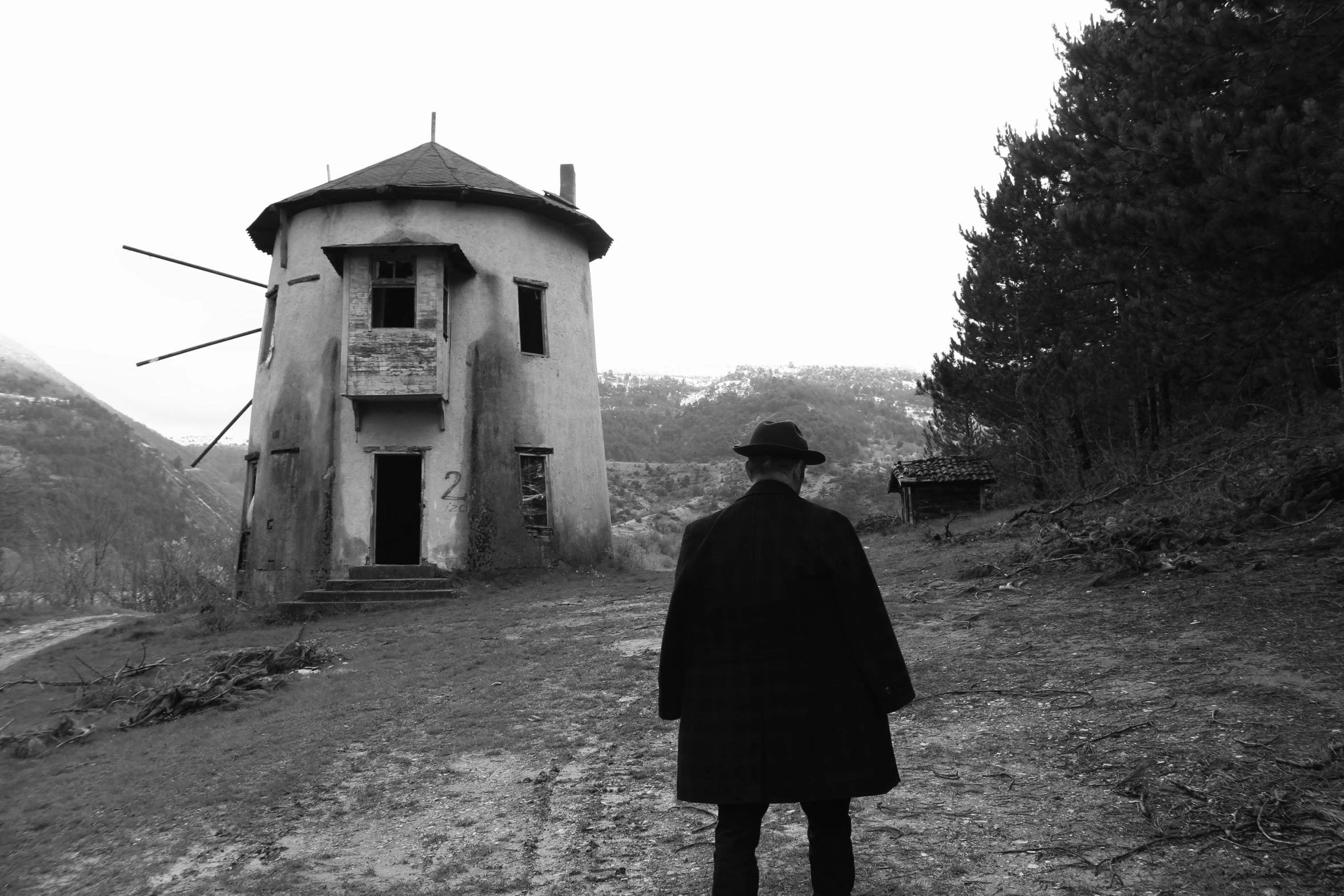 a man walking towards a building on the side of a road