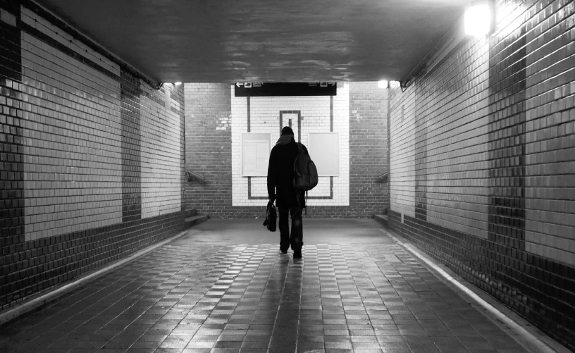 a person is walking in the hallway of a building