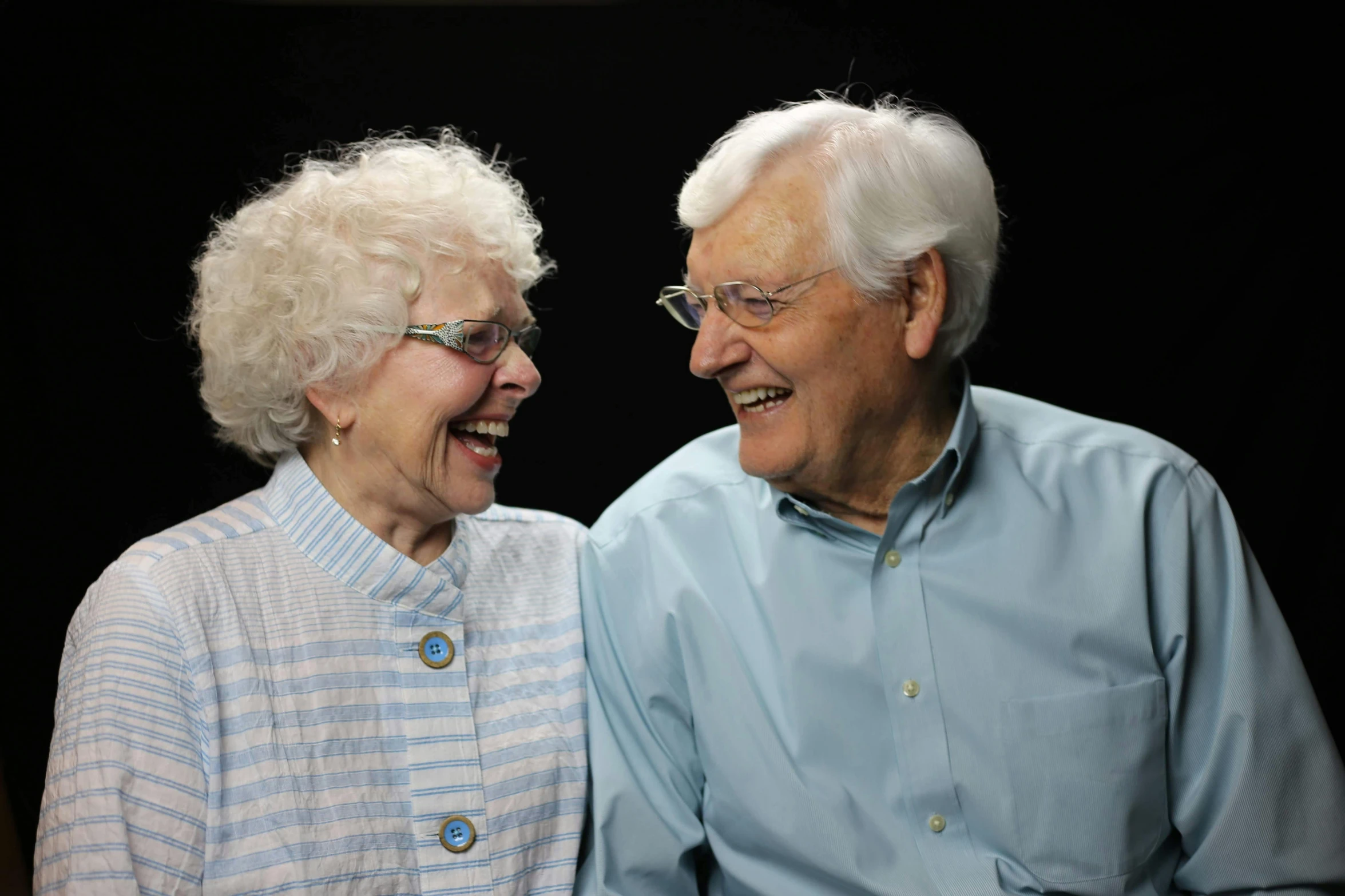 an older man and an older woman smiling