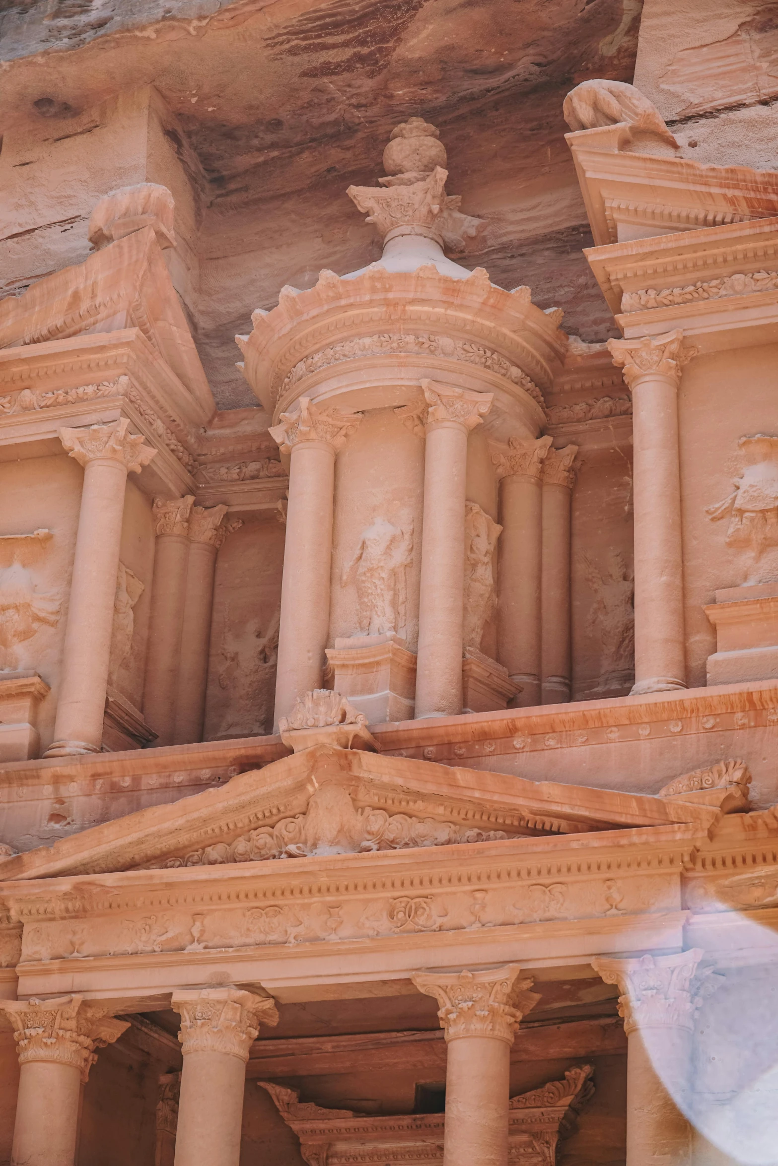 some ancient architecture in an old town with a statue of a person