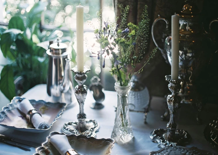 an elegantly set table with silver and glass