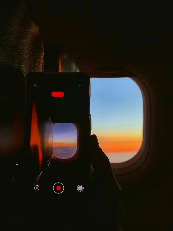 the camera of a airplane as it is reflected in the window