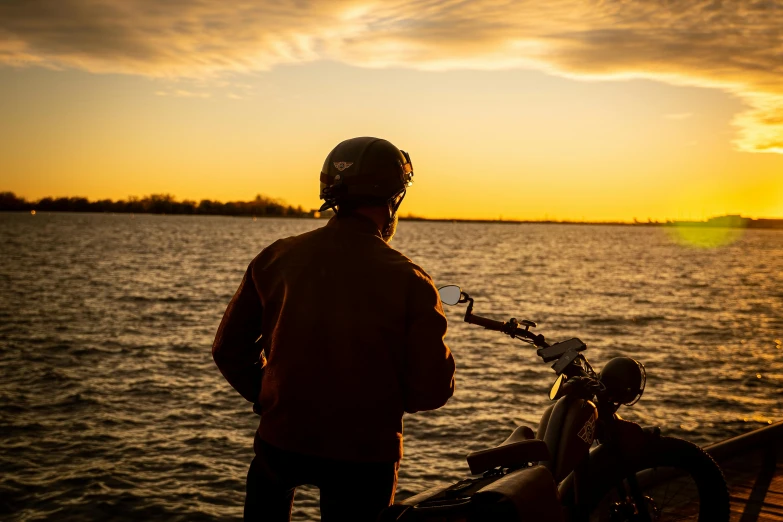 a man holding a bike on top of a boat