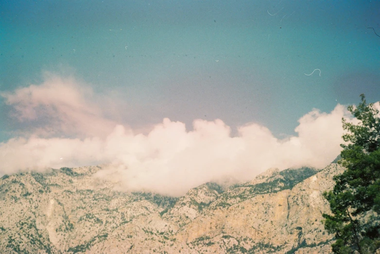 a mountain view with clouds in the sky