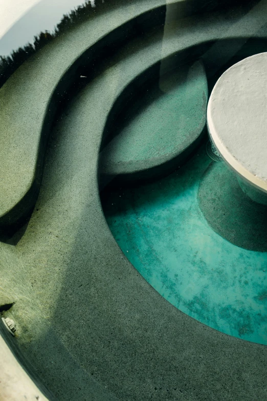 an oval table and planter placed in the middle of the floor