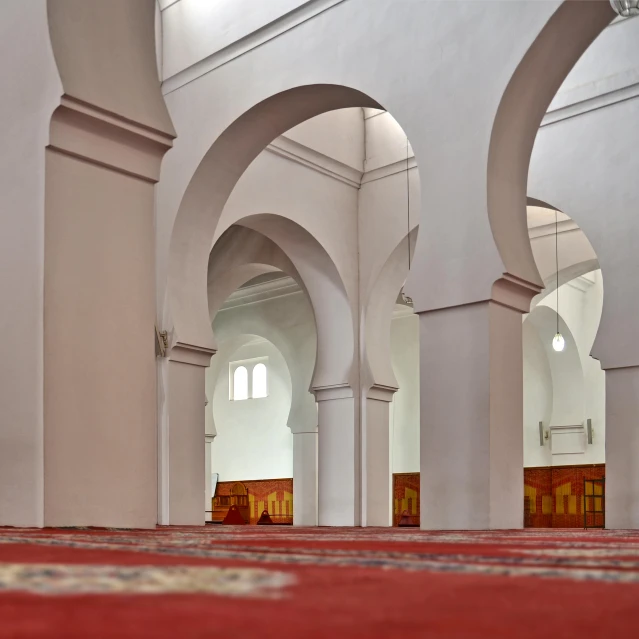 several arches in the building near a carpet