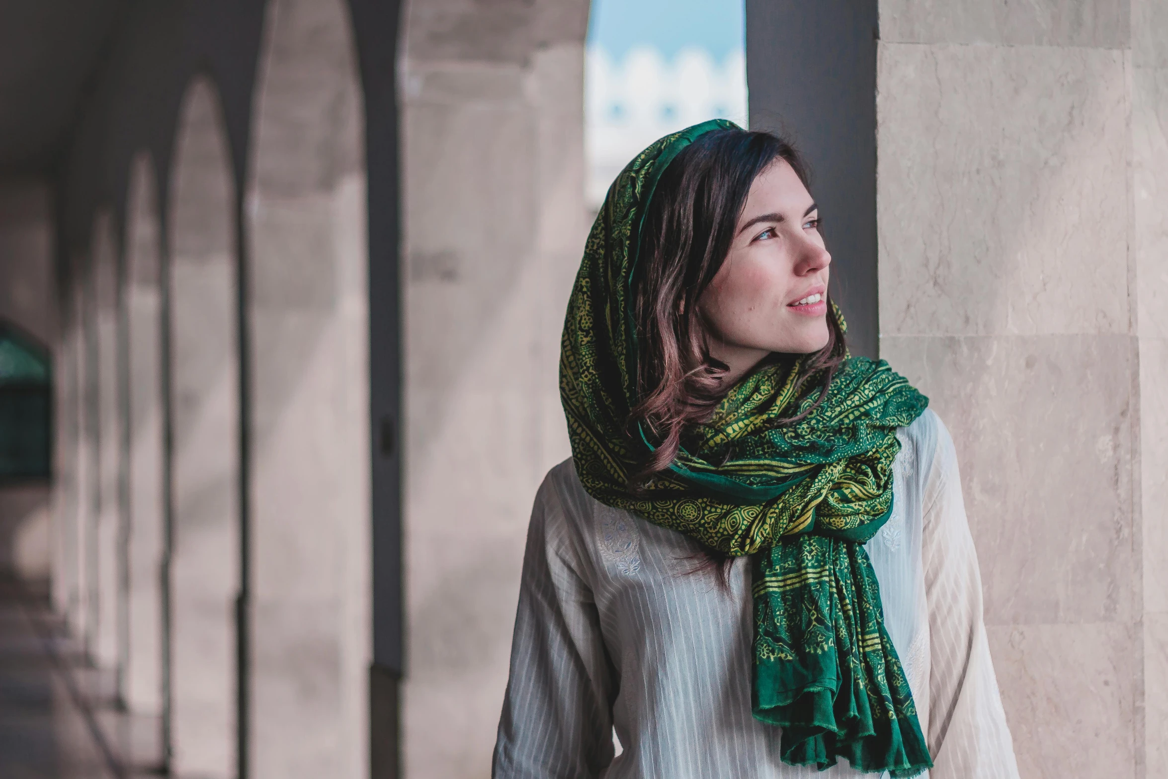 a woman wearing a scarf with a long fringe around her head