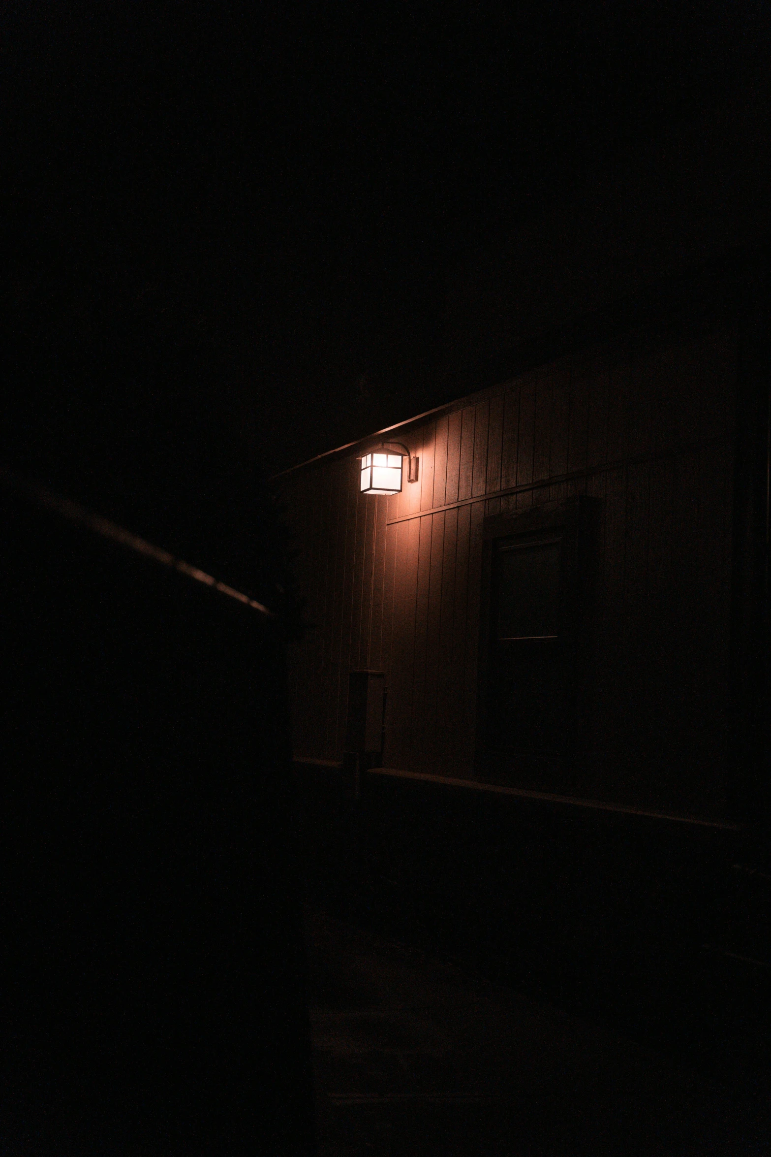 a small lighted street light in a dark area