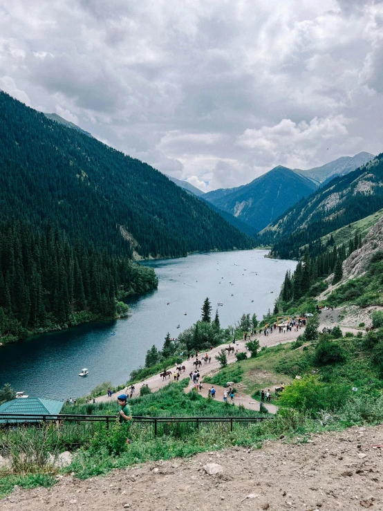 many people on the side of a large body of water