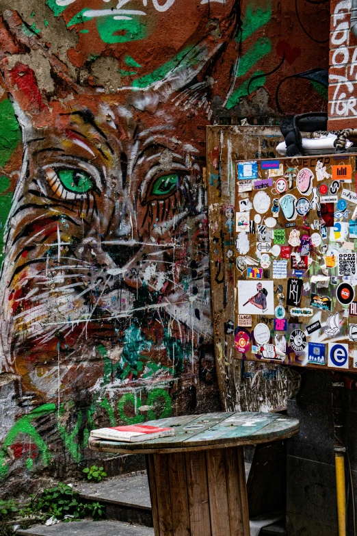 a graffiti covered wall with a street sign