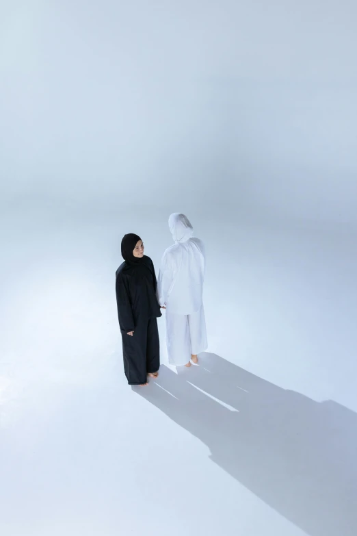 two people are facing each other on a white background