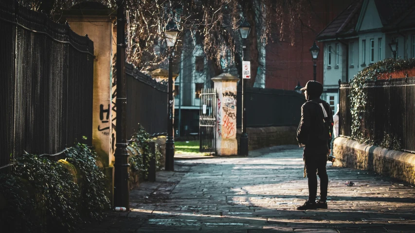 a person standing on a sidewalk in the dark