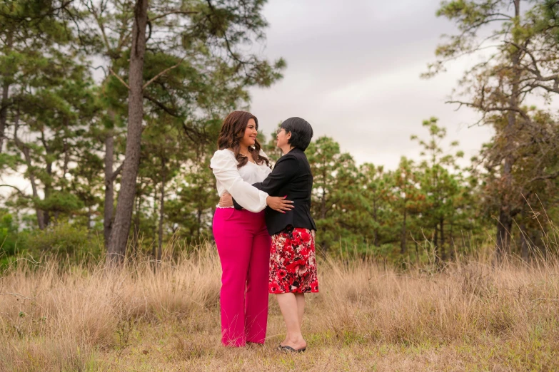 a couple emcing each other in the middle of a field