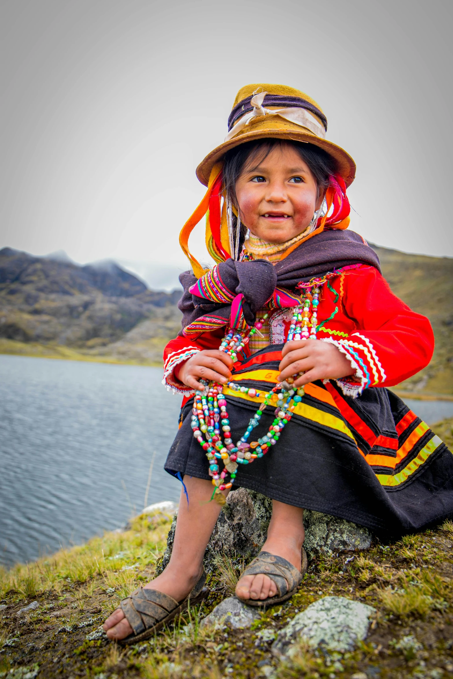 the young child is dressed in colorful clothing