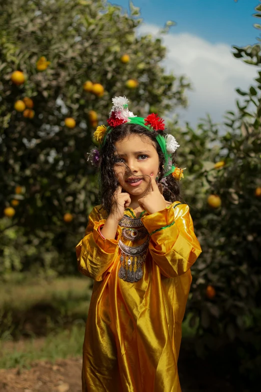 a little girl dressed up in a yellow costume outside