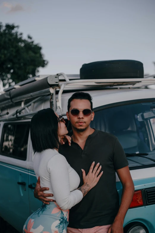 couple standing together in front of a van