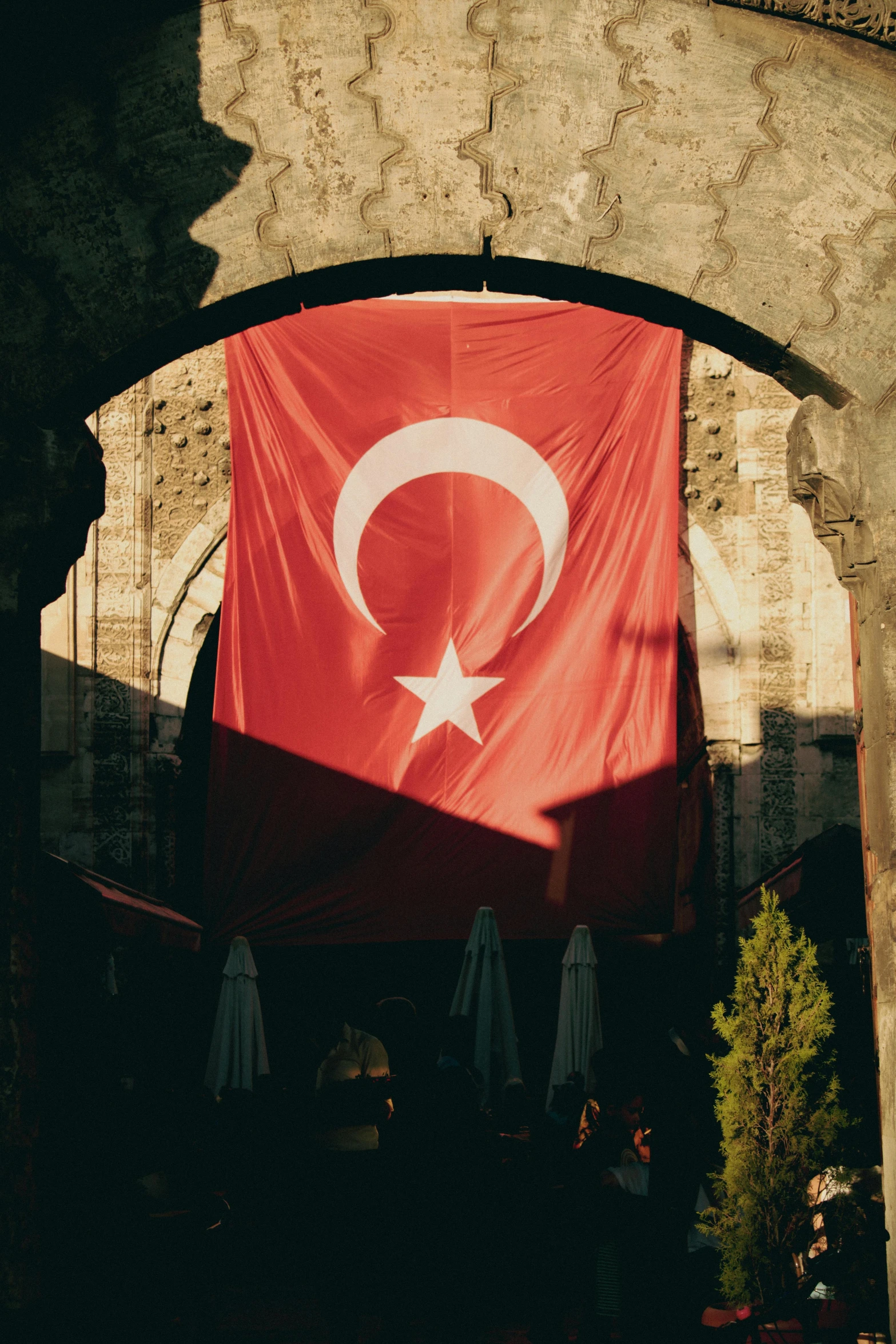 a red flag is on display in an archway