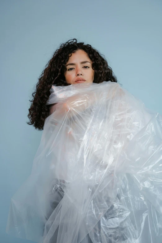 a woman holding a plastic bag behind her back