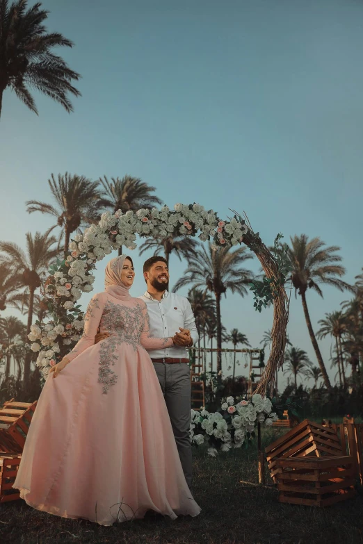 a man and woman in formal wear posing for the camera