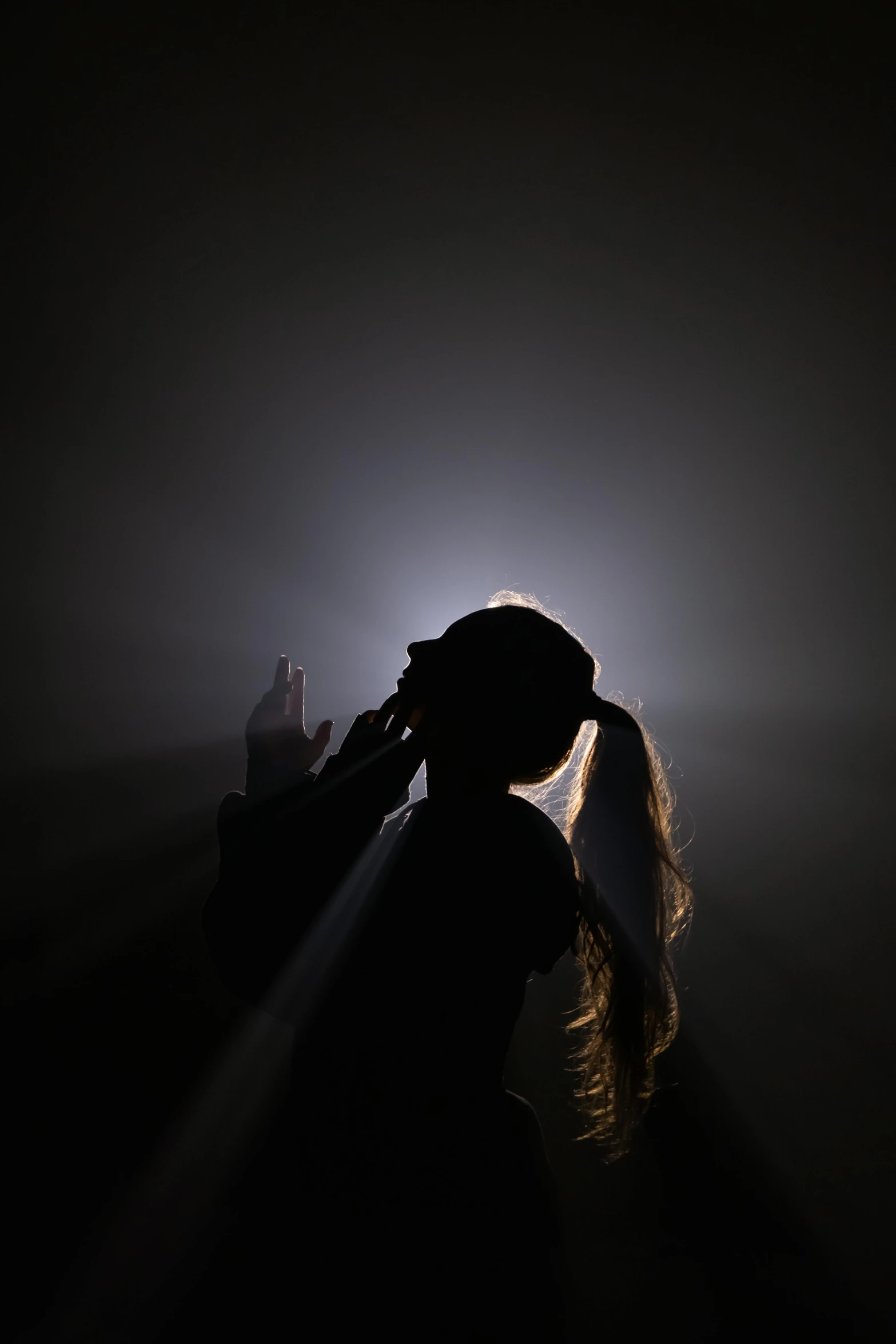 a person is standing in a darkened room