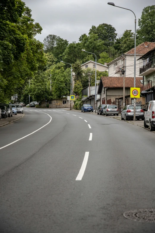 a street in a neighborhood with cars parked along it