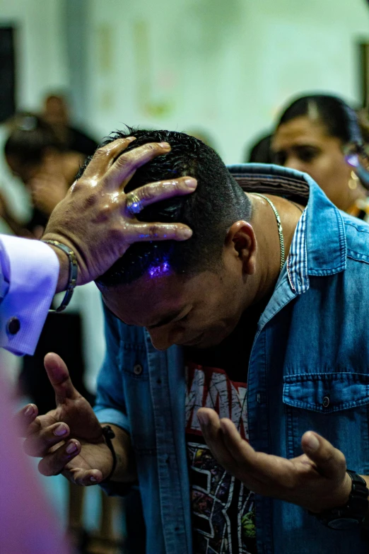 a man holding his head with both hands