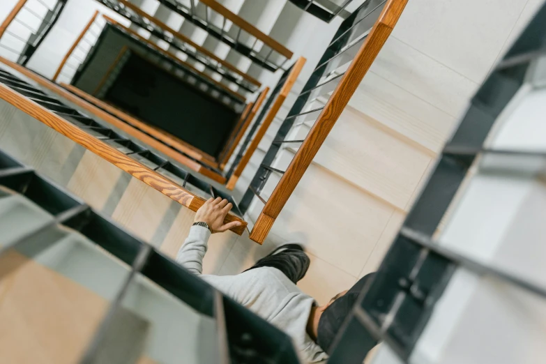 woman on stairwell of warehouse with metal handrails