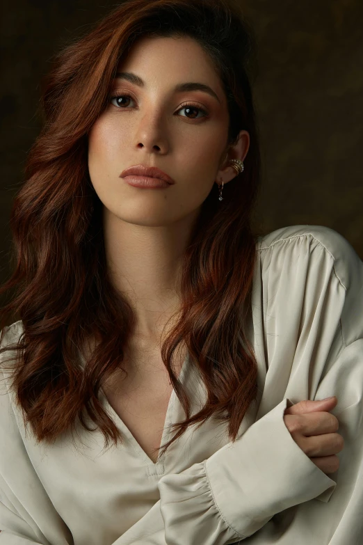 a woman wearing a white shirt with a red hair